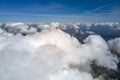 Aerial view from airplane window at high altitude of earth covered with white puffy cumulus clouds Royalty Free Stock Photo