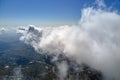 Aerial view from airplane window at high altitude of earth covered with white puffy cumulus clouds Royalty Free Stock Photo