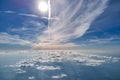 Aerial view from airplane window at high altitude of earth covered with white thin layer of misty haze and distant clouds Royalty Free Stock Photo