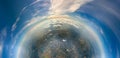 Aerial view from airplane window at high altitude of little planet distant city covered with layer of thin misty smog