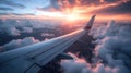 Aerial view of airplane wing in the clouds at sunset. Travel concept Royalty Free Stock Photo