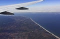 Aerial view of an airplane wing over California coast