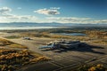 An aerial view of an airport with planes parked on the airport tarmac.