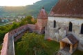 Aerial view of Alma Vii fortified church, with sun flare, at sunset. Typical fortification in Transylvania region, Romania. Royalty Free Stock Photo