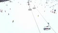 Aerial view of an alpine ski slope and chairlift in action