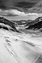 Aerial view of the Alps mountains in Switzerland. View from helicopter in Swiss Alps. Mountain tops in snow. Royalty Free Stock Photo