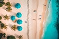 Aerial view of amazing beach with umbrellas and lounge chairs beds close to turquoise sea. Top view of summer beach landscape,