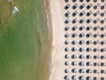 Aerial view of an amazing empty sand beach with straw beach umbrellas and turquoise clear water. Bulgaria Black Sea Royalty Free Stock Photo