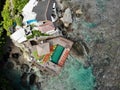 Aerial view of an amazing little surfer village on the rock cliff and coastline. Royalty Free Stock Photo