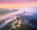 Aerial view of amazing park near river and railway bridge in fog Royalty Free Stock Photo