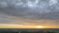 Aerial view amazing sunset over of the suburbs with the city under dramatic rain cloud. Global warming effect black Royalty Free Stock Photo