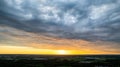 Aerial view amazing sunset over of the suburbs with the city under dramatic rain cloud. Global warming effect black Royalty Free Stock Photo