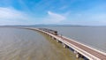 Aerial view of an amazing travel train parked on a floating railway bridge over the water of the lake in Pa Sak Jolasid dam with b