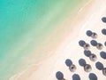 Aerial view of amazing tropical white sandy beach with palm leaves umbrellas and turquoise sea. Royalty Free Stock Photo