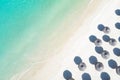 Aerial view of amazing tropical white sandy beach with palm leaves umbrellas and turquoise sea. Royalty Free Stock Photo