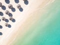 Aerial view of amazing tropical white sandy beach with palm leaves umbrellas and turquoise sea. Royalty Free Stock Photo