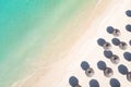 Aerial view of amazing tropical white sandy beach with palm leaves umbrellas and turquoise sea. Royalty Free Stock Photo