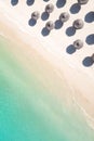 Aerial view of amazing tropical white sandy beach with palm leaves umbrellas and turquoise sea. Royalty Free Stock Photo