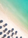 Aerial view of amazing tropical white sandy beach with palm leaves umbrellas and turquoise sea. Royalty Free Stock Photo