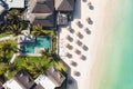 Aerial view of amazing tropical white sandy beach with palm leaves umbrellas and turquoise sea, Mauritius. Royalty Free Stock Photo