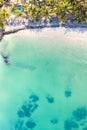 Aerial view of amazing tropical white sandy beach with palm leaves umbrellas and turquoise sea, Mauritius. Royalty Free Stock Photo