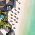 Aerial view of amazing tropical white sandy beach with palm leaves umbrellas and turquoise sea, Mauritius. Royalty Free Stock Photo