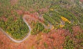 Aerial view of an amazing winding curved road through the mountains in autumn fall colors landscape, motorway in Romania Royalty Free Stock Photo