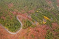 Aerial view of an amazing winding curved road through the mountains in autumn fall colors landscape, motorway in Romania Royalty Free Stock Photo