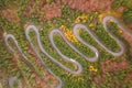 Aerial view of an amazing winding curved road through the mountains in autumn fall colors landscape, motorway in Romania Royalty Free Stock Photo