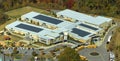 Aerial view of american school building with rooftop covered with photovoltaic solar panels for production of electric Royalty Free Stock Photo