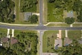 Aerial view of american small town in Florida with private homes between green palm trees and suburban streets in quiet