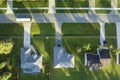 Aerial view of american small town in Florida with private homes between green palm trees and suburban streets in quiet