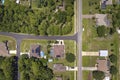 Aerial view of american small town in Florida with private homes between green palm trees and suburban streets in quiet