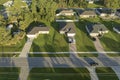 Aerial view of american small town in Florida with private homes between green palm trees and suburban streets in quiet