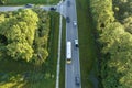 Aerial view of american yellow school bus driving on suburban street for picking up children for their lessongs in early