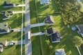 Aerial view of american yellow school bus driving on suburban street for picking up children for their lessongs in early