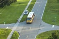 Aerial view of american yellow school bus picking up children at sidewalk bus stop for their lessongs in early morning