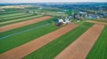 Aerial View of Amish Farms and Countryside on a Spring Day with Green and Brown Fields