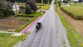 Aerial View of an Amish Horse and Buggy Travel on a Countryside Road, Passing Corn Fields Royalty Free Stock Photo