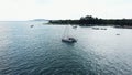 Aerial View of a Anchored Catamaran Yacht Standing and people can Sunbathing on it`s Deck.