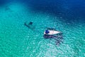 Aerial view of anchored sailing yacht in emerald sea. Aerial view of a boat. Outdoor water sports, yachting. Aerial view of Royalty Free Stock Photo