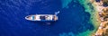 Aerial view of anchored sailing yacht in emerald sea. Aerial view of a boat. Outdoor water sports, yachting. Aerial view of Royalty Free Stock Photo