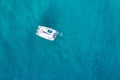 Aerial view of anchored sailing yacht in emerald sea. Aerial view of a boat. Outdoor water sports, yachting. Aerial view of Royalty Free Stock Photo