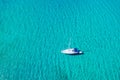 Aerial view of anchored sailing yacht in emerald sea. Aerial view of a boat. Outdoor water sports, yachting. Aerial view of Royalty Free Stock Photo