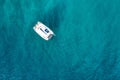 Aerial view of anchored sailing yacht in emerald sea. Aerial view of a boat. Outdoor water sports, yachting. Aerial view of Royalty Free Stock Photo