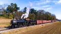 Aerial View of an Antique Steam Freight Passenger Train Blowing Smoke as it Slowly Travels