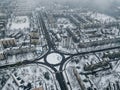 aerial view of apartment buildings on snowy streets with roundabout