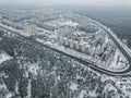 aerial view of apartment buildings on snowy streets surrounded with forest