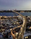 Aerial view of April 25th bridge with Christ the King statue Cristo Rei in background at sunset, view of Lisbon skyline at night Royalty Free Stock Photo