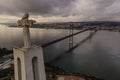 Aerial view of April 25th bridge and Cristo Rei Christ the King at sunset over the Tagus river, Almada, Lisbon, Portugal Royalty Free Stock Photo